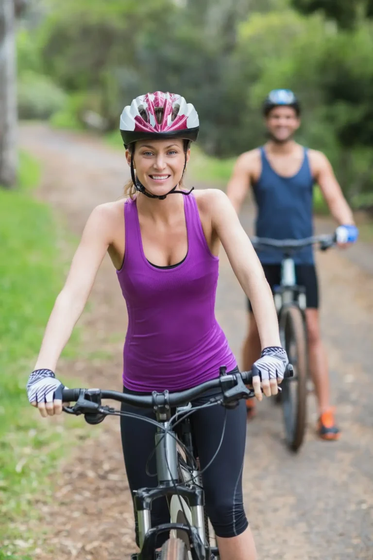 Couple riding bicycles together, enjoying outdoor cycling adventures in nature – perfect for travel, beach days, or mountain rides.